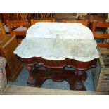 A Victorian mahogany demi lune marble top washstand with a raised marble back and soap shelf.