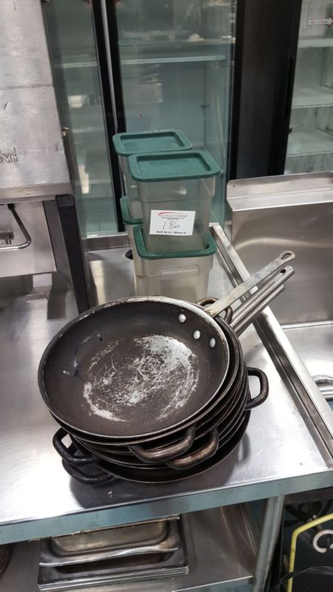 4 storage bins and assorted fry pans