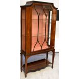 An Edwardian mahogany inlaid display cabinet with glazed doors and sides with two interior glass