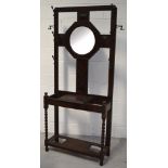 An early to mid 20th century oak hall stand with central octagonal mirror,