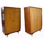 A retro 1960s two door wardrobe with integral shelving, raised on tapering block supports,