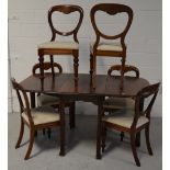 An oak dropleaf dining table on reeded legs,