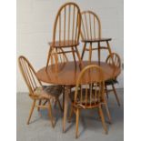 A retro Ercol oval dining table, length when extended 124cm,