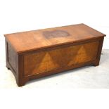 A 20th century blanket box on bracket feet, width 124cm.