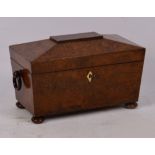 An early Victorian burr yew wood sarcophagus tea caddy, the hinged lid enclosing two lidded
