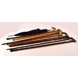 A collection of walking sticks and canes including silver mounted examples, Japanese fishing rod,