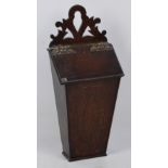 A Georgian oak salt/candle box with fretwork to the top and with pierced decorative hinges,