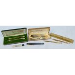 A collection of pens and propelling pencils including two gold plated pen and pencil sets by