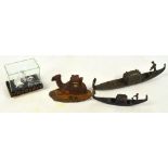A metal inkwell modelled as a Venetian gondola, length 29cm, a further smaller example,