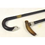 An ebonised shafted horn handled walking stick with silver collar, and a further walking stick