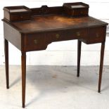 An early 20th century mahogany leather inset desk on tapering legs, width 92cm.