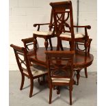 A reproduction mahogany extending dining table on quadripartite base,