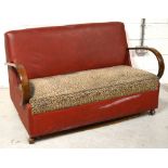 An early 20th century two seater red faux leather and bentwood sofa, width 145cm.