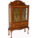 An Edwardian mahogany and inlaid display cabinet with twin astragal glazed doors above front