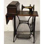 An oak cased cabinet Singer treadle sewing machine, width 78cm.