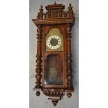 A mahogany Vienna style eight day wall clock the dial contained within gilt metal frame and set