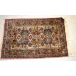 A small Oriental rug, red and cream ground with geometric pattern, 90 x 60cm.