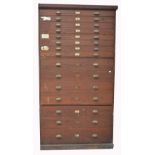 An early 20th century architects plan chest with 15 graduated drawers with brass dimple handles,