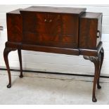 A 20th century flame mahogany cocktail cabinet with integral accessories for making cocktails to