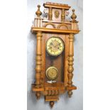 A 20th century oak cased eight day spring driven Vienna style wall clock,