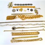 A quantity of costume jewellery to include yellow metal link bracelets, chains, various earrings,