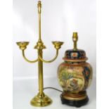 A brass table lamp with fluted column support and an Oriental style ceramic table lamp on ebonised