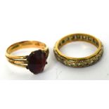 A 9ct gold ring set with a central red stone,