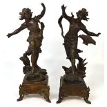 A pair of spelter figures of ladies, one carrying a basket,
