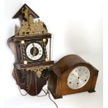 A Gothic inspired mahogany wall clock with brass attachments,