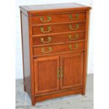 A 20th century Oriental hardwood cutlery cabinet with four drawers over two narrow cupboard doors