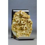 A Chinese pale celadon russet included pierced and carved jade plaque decorated throughout with