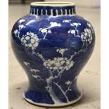 An early 20th century Chinese blue and white baluster vase decorated with cherry blossom,