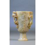 A Chinese carved celadon jade and russet included cup,