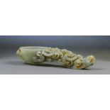 A Chinese carved jade and slight russet included libation spoon with detailed carved handle in the