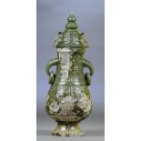 A Chinese jade and russet included twin handled vase and cover with drop ring handles and stylised