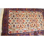 An Oriental rug, blue and cream ground with Persian garden floral decoration and geometric border,