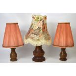 Three wood table lamps to include a retro baluster table lamp with full shade and a pair of turned