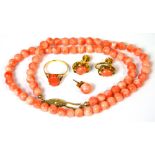 A coral necklace with yellow metal clasp, a pair of coral earrings in yellow metal mounts,