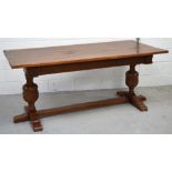 A 20th century rectangular oak dining table on carved bulbous supports with conjoining stretcher,