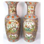 A large pair of 19th century Chinese famille rose vases each decorated with floral sprays within