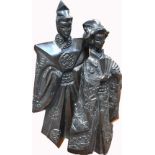 A large Oriental 20th century ebonised pottery figure group depicting a couple in traditional dress,