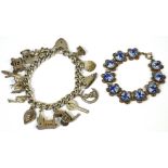 A hallmarked silver charm bracelet set with various silver charms to include a crocodile and a