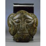 A Chinese carved jade priests mask, possibly neolithic and well infiltrated, approx 1.