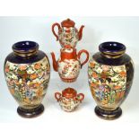 A pair of 20th century blue ground and gilt heightened vases, decorated with geisha girls,