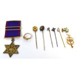 A masonic jewel, a 9ct gold cased stick pin with shield shaped finial,