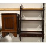 A mahogany Oriental inspired wall mounted book shelf with two lower drawers,