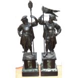 A pair of French inspired spelter figures on square section slate / marble,