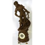 A large spelter clock modelled as a fisherman holding a wheel, enamel dial set with Arabic numerals,