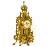 A reproduction ornate heavy brass mantel clock,