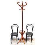 A 20th century bentwood free standing coat/umbrella stand and a pair of similar ebonised chairs (3).